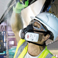 man wearing a reusable half mask 