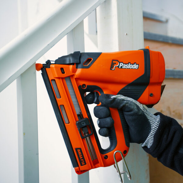 Joiner fixing stair rods with a Paslode IM65A Nail Gun